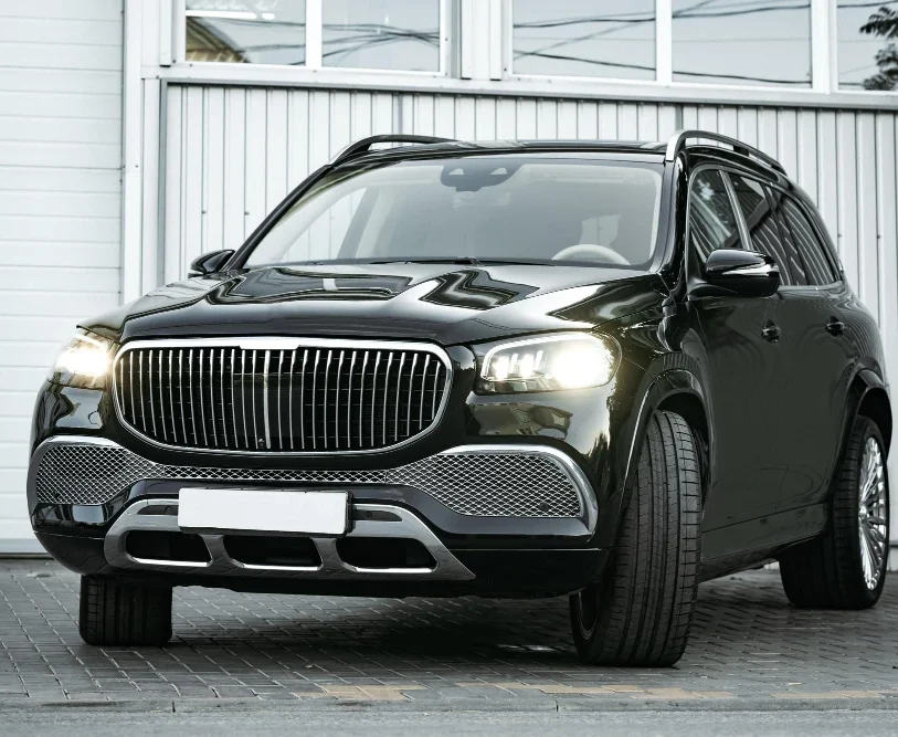 Luxury black SUV parked in front of a building, showcasing its sleek design and modern features, relevant to North Cab Taxi's commitment to comfortable and professional transportation services in Burlington, VT.